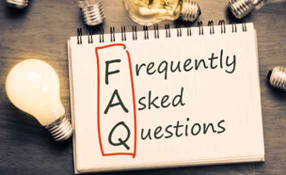 FAQ ( frequently asked questions ) text on notebook with many light bulbs