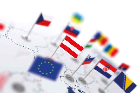 Austria flag in the focus. Europe map with countries flags